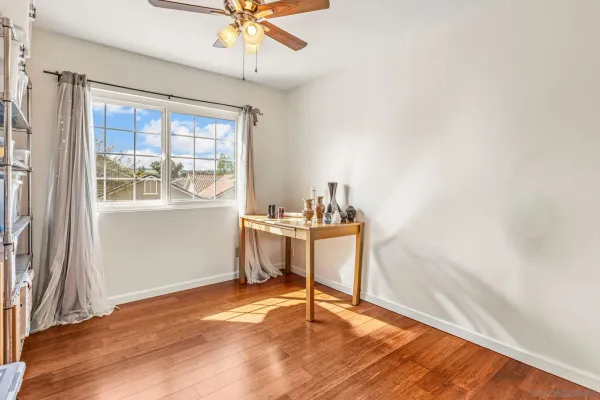 a view of a room with a window and wooden floor