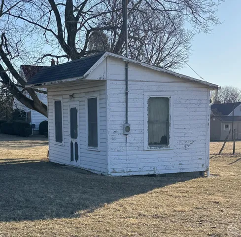 a body of water with a tree in the background