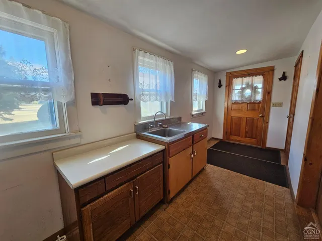 a kitchen with sink cabinets and window