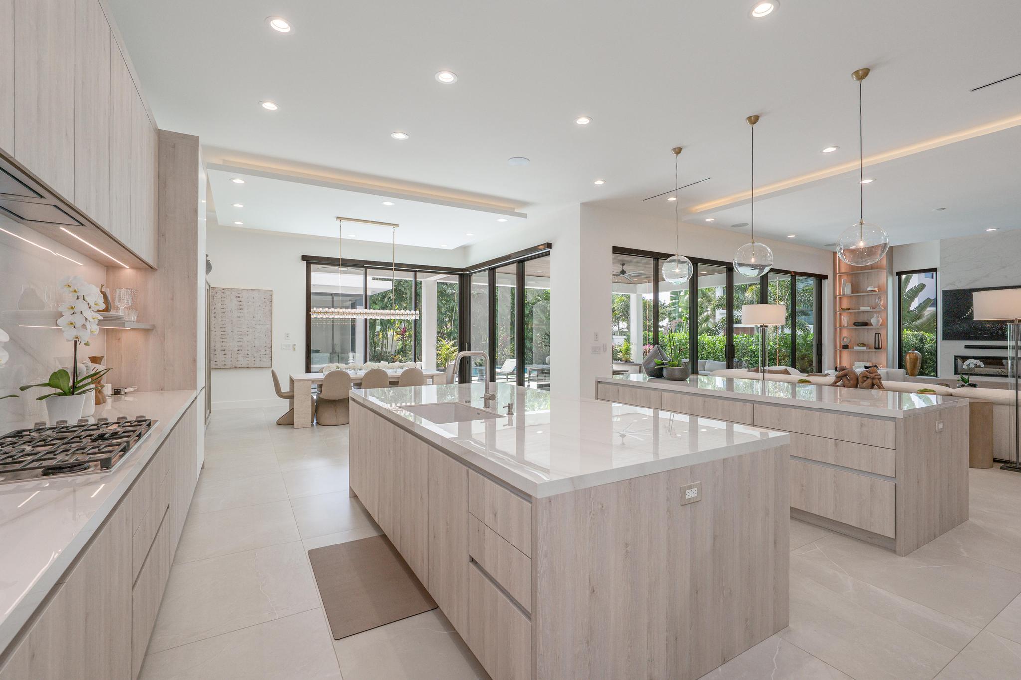 400 Northeast 4th Street Boca Raton, FL 33432 - Photo 15 of 73 a large kitchen with kitchen island a large window a sink and stainless steel appliances