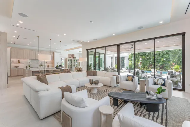 a kitchen with white cabinets and chairs