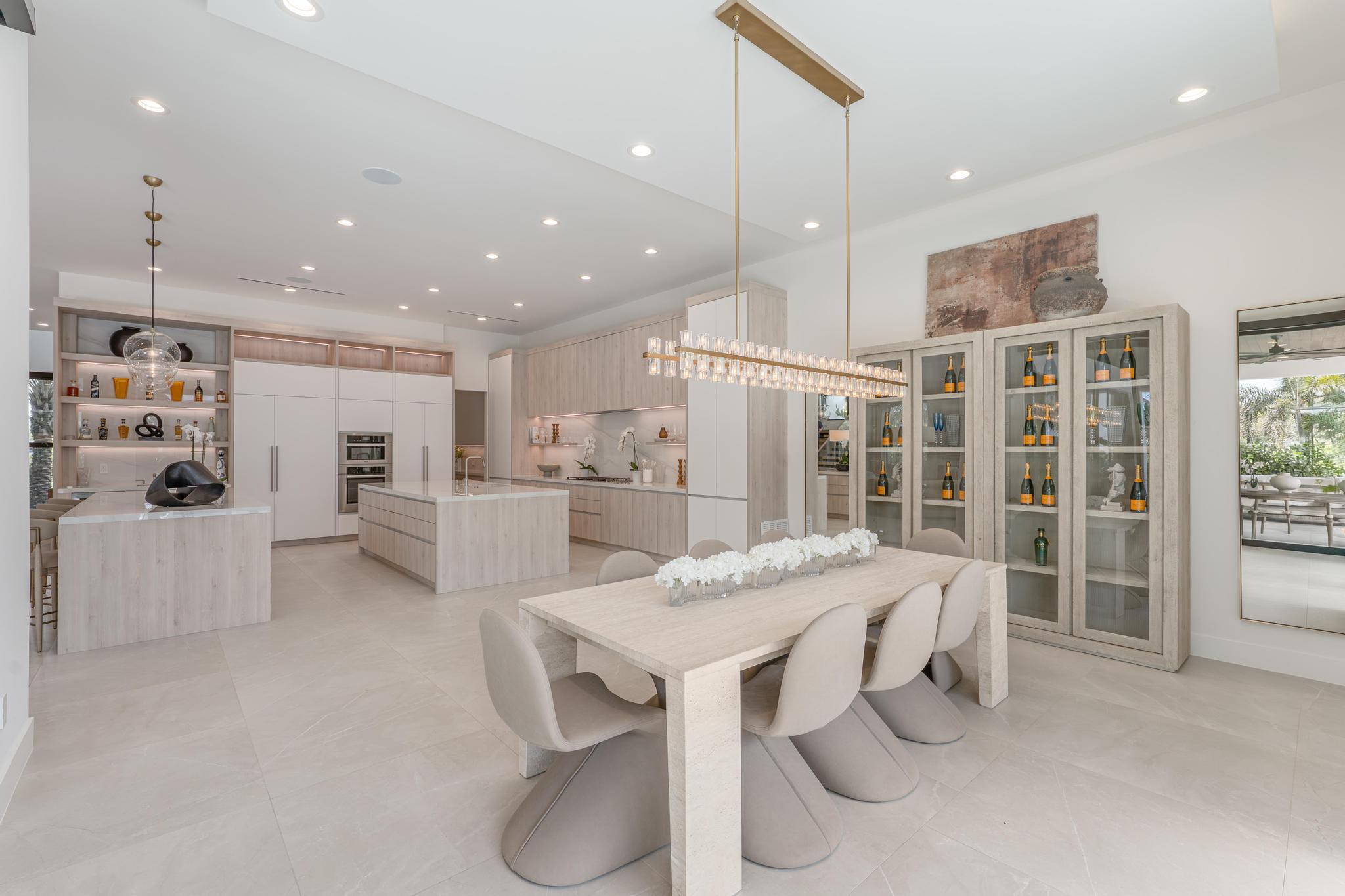 400 Northeast 4th Street Boca Raton, FL 33432 - Photo 19 of 73 a kitchen with stainless steel appliances kitchen island granite countertop a table chairs and a refrigerator