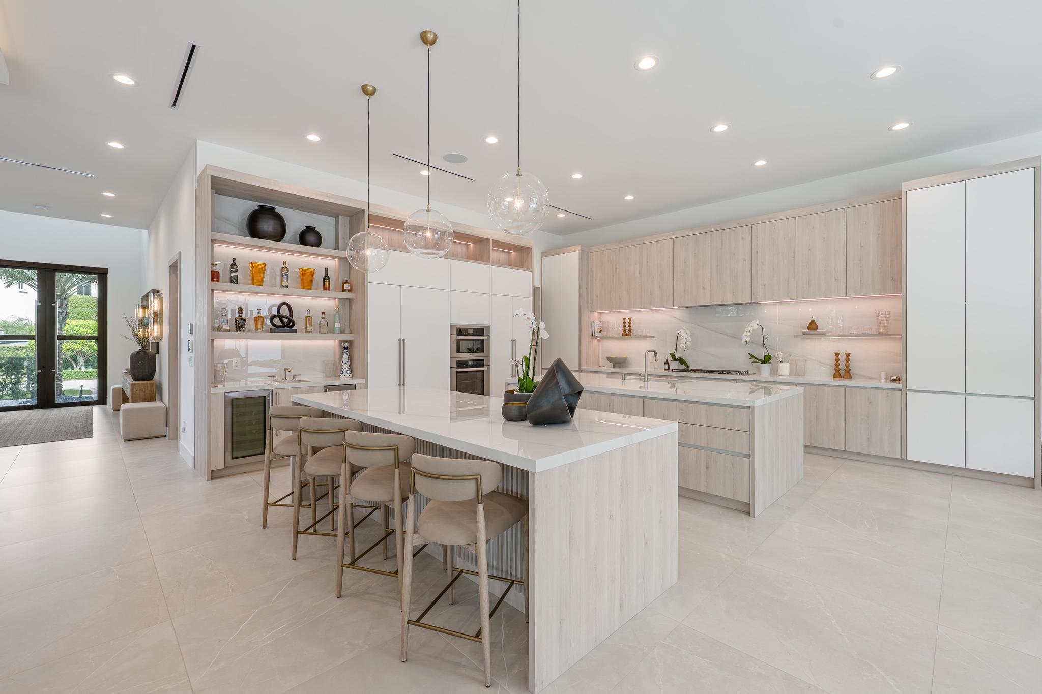 400 Northeast 4th Street Boca Raton, FL 33432 - Photo 20 of 73 a kitchen with white cabinets and chairs