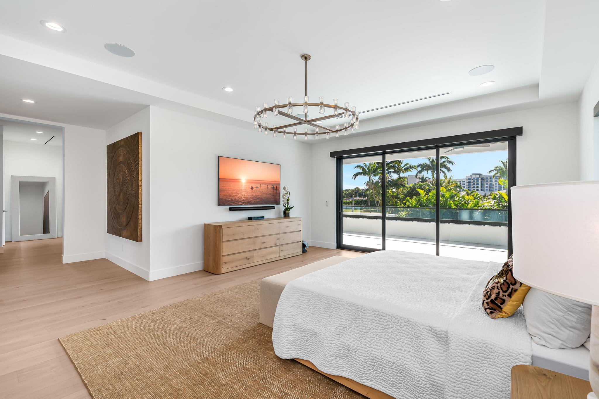 400 Northeast 4th Street Boca Raton, FL 33432 - Photo 36 of 73 a bedroom with furniture and a flat screen tv