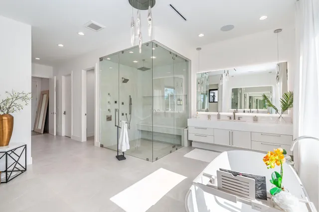 a aerial view of a house with swimming pool and glass top table and chairs