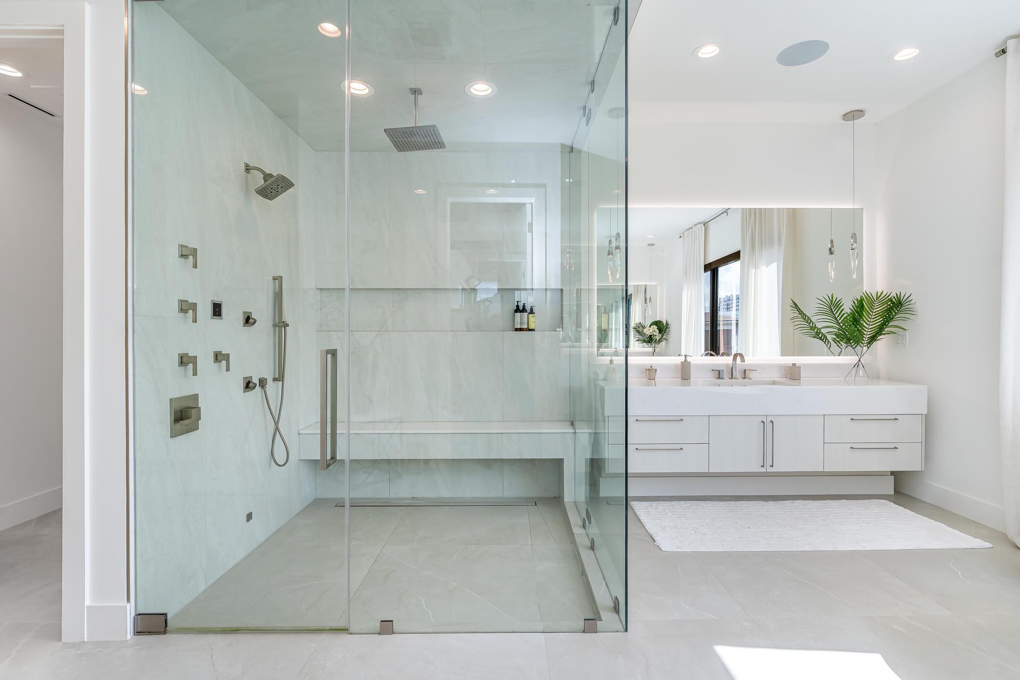 400 Northeast 4th Street Boca Raton, FL 33432 - Photo 41 of 73 a bathroom with a glass shower door a sink and a bathtub