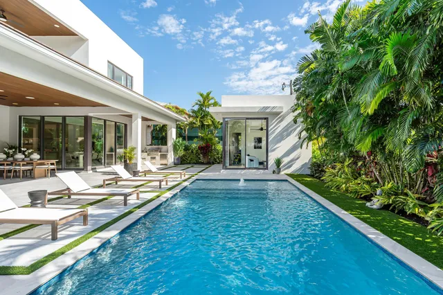 a kitchen with stainless steel appliances granite countertop a sink a stove and a wooden floors