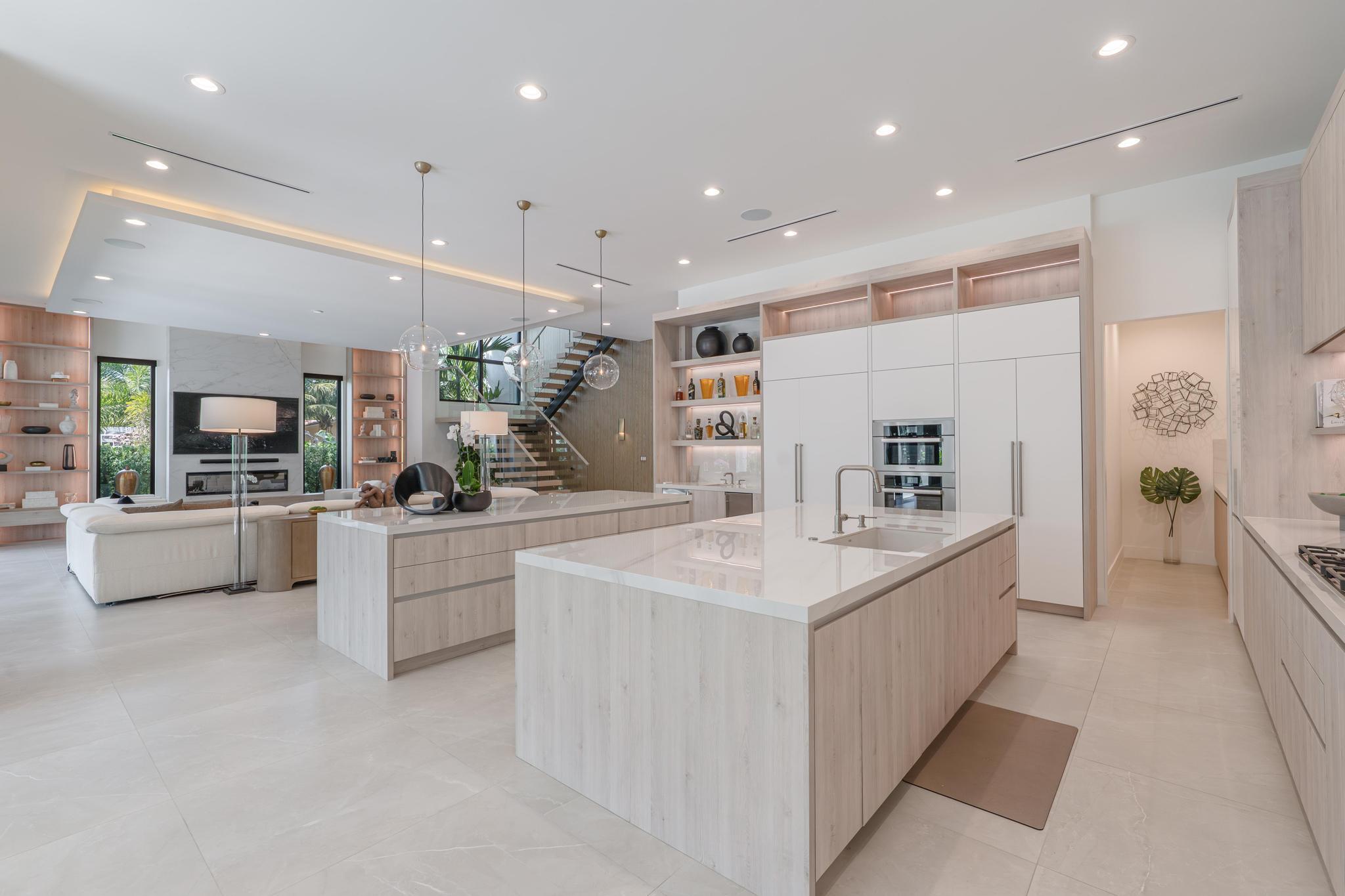 400 Northeast 4th Street Boca Raton, FL 33432 - Photo 10 of 73 a large white kitchen with a large counter top stainless steel appliances and chandelier