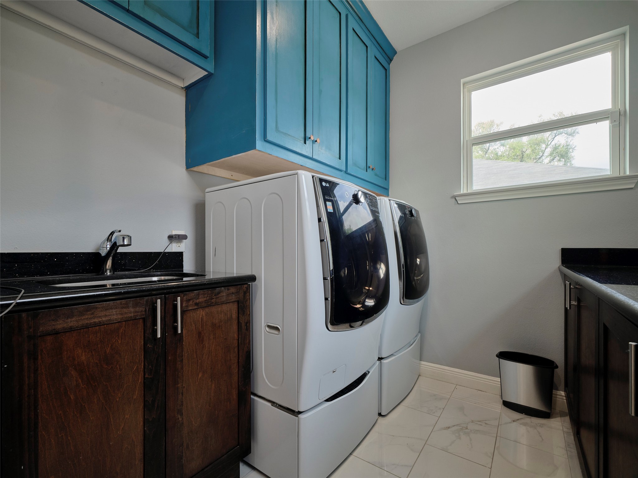 4219 Redbud Street Houston, TX 77051 - Photo 16 of 25 Discover a functional laundry room brimming with ample cabinetry, perfect for all your storage needs.