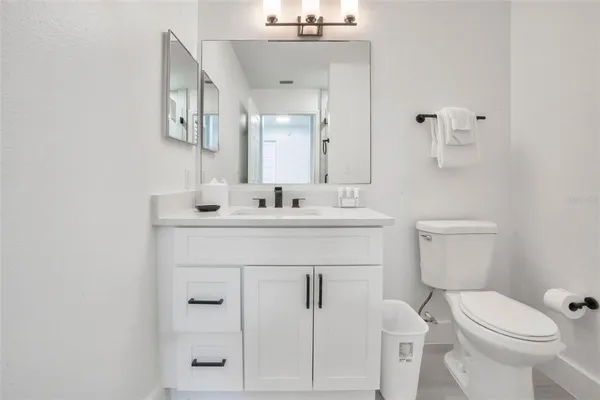 a bathroom with a sink vanity and a toilet