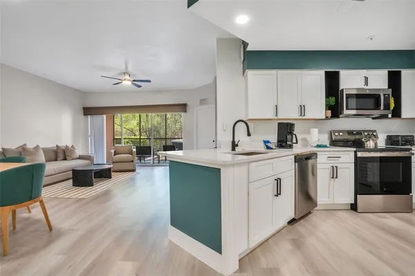 a kitchen with a sink cabinets and window