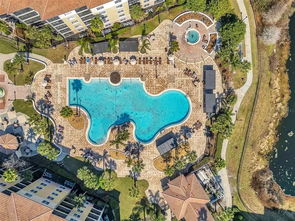 an aerial view of a house with a swimming pool and outdoor seating