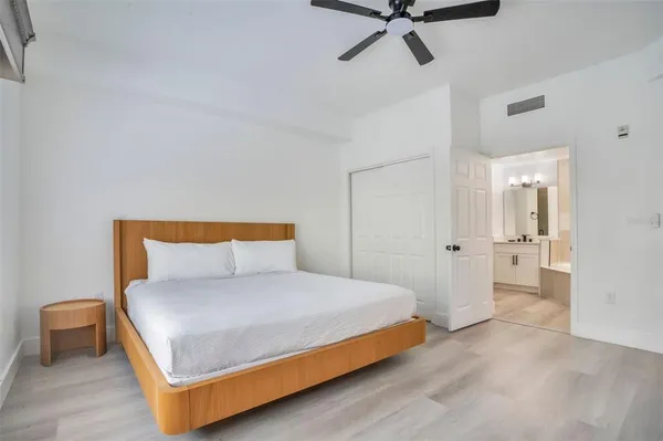 a bedroom with a bed and cabinet