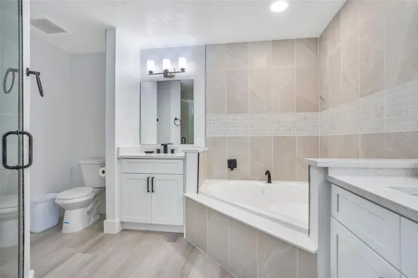 a bathroom with a sink toilet a mirror and shower