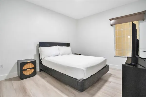 a bed sitting in a bedroom next to a window