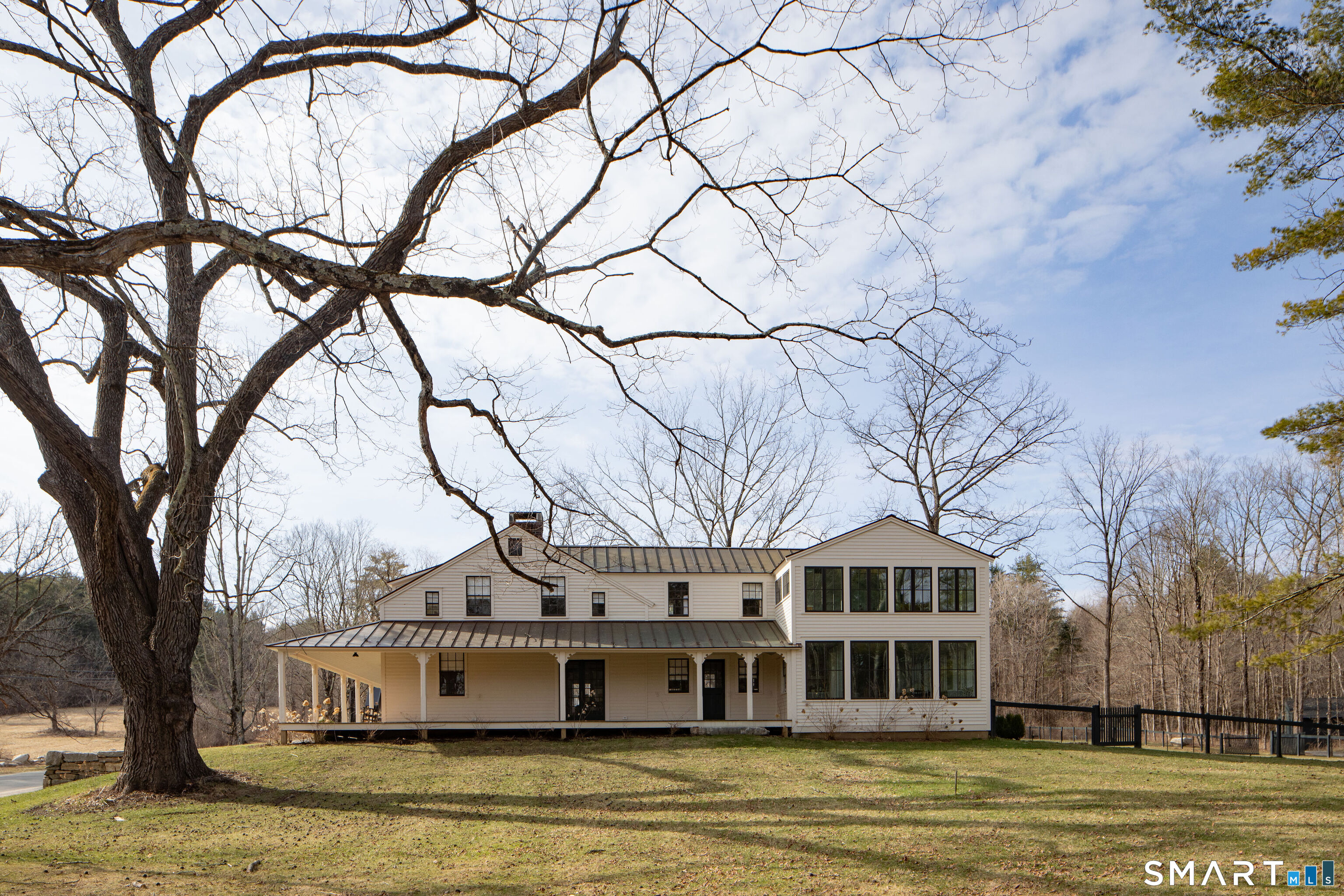 40 Music Mountain Road Canaan, CT 06031 - Photo 4 of 32 a front view of a house with a yard covered with trees
