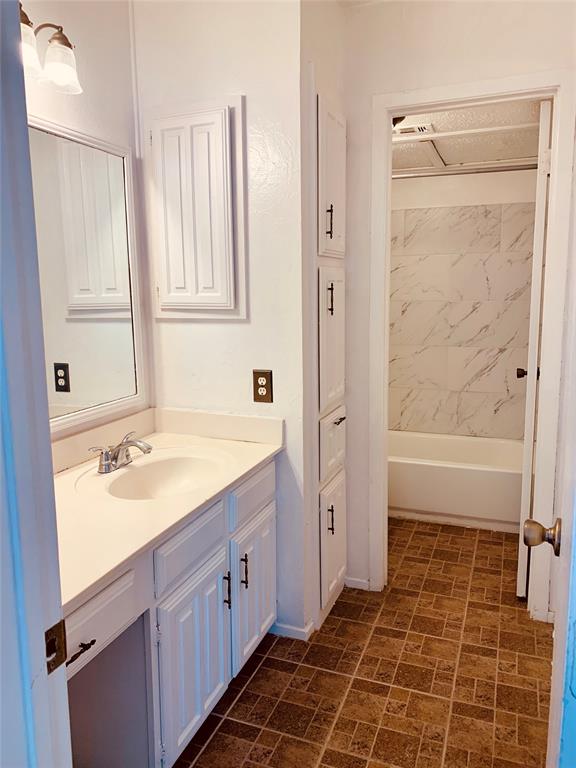 333 Melrose Drive, Unit 25A Richardson, TX 75080 - Photo 12 of 18 a bathroom with a granite countertop sink toilet and shower
