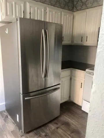 a metallic refrigerator freezer sitting in a kitchen