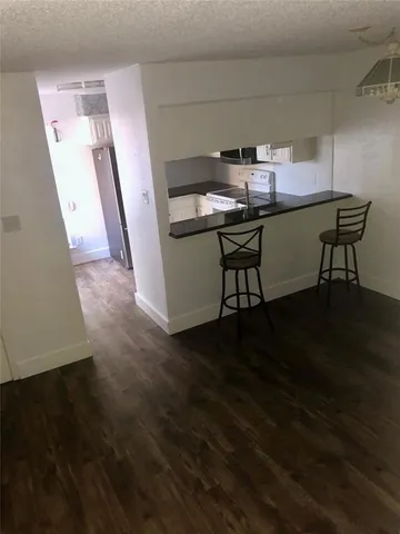 a room with wooden floor and furniture