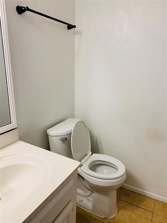 333 Melrose Drive, Unit 25A Richardson, TX 75080 - Photo 9 of 18 a white toilet sitting next to a bathroom sink