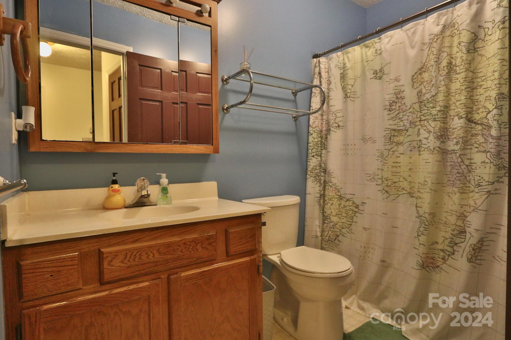 124 Maple Ridge Drive King, NC 27021 - Photo 23 of 40 a bathroom with a granite countertop sink toilet and shower