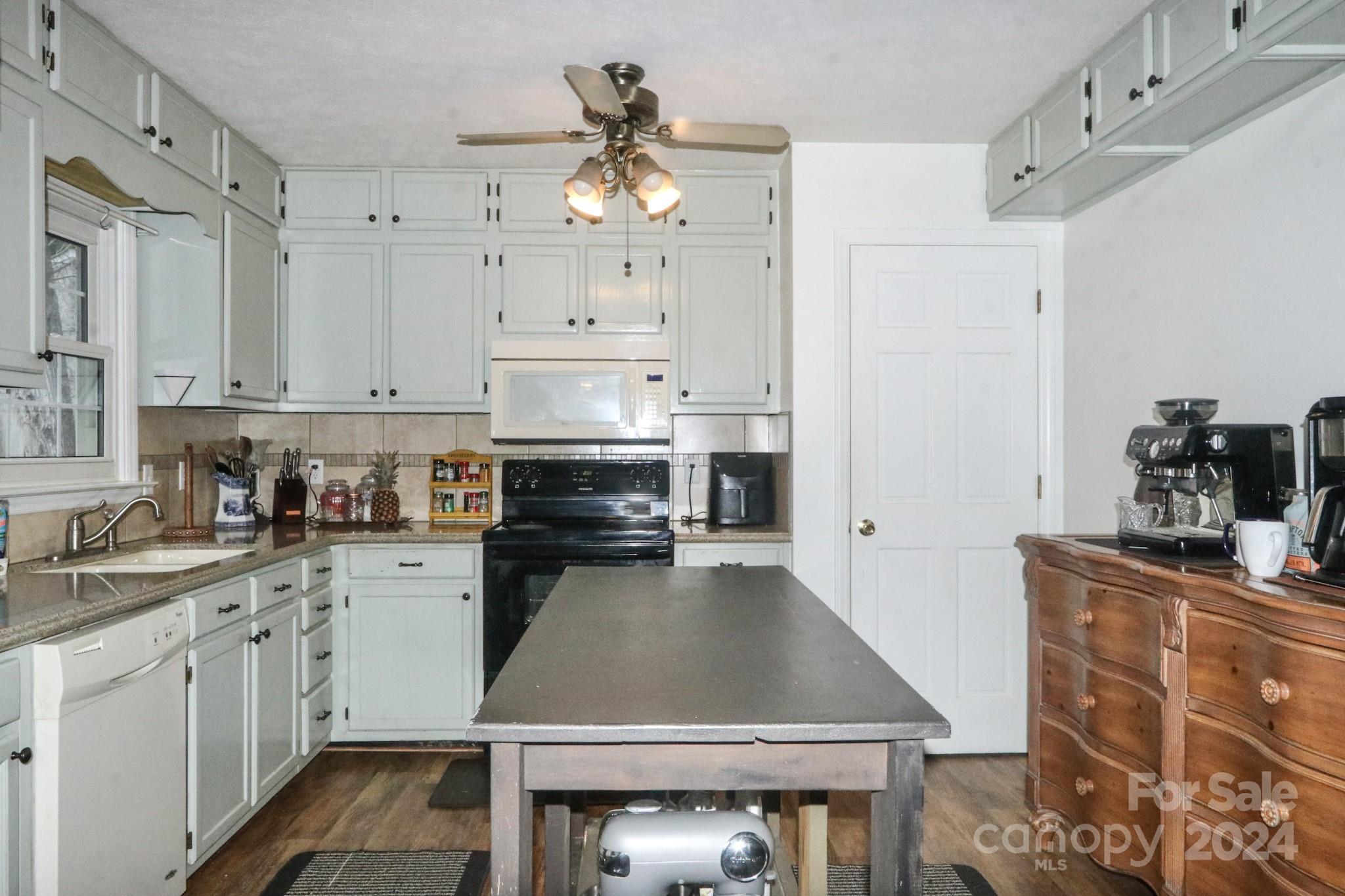 124 Maple Ridge Drive King, NC 27021 - Photo 7 of 40 a kitchen with kitchen island granite countertop a sink a stove and cabinets