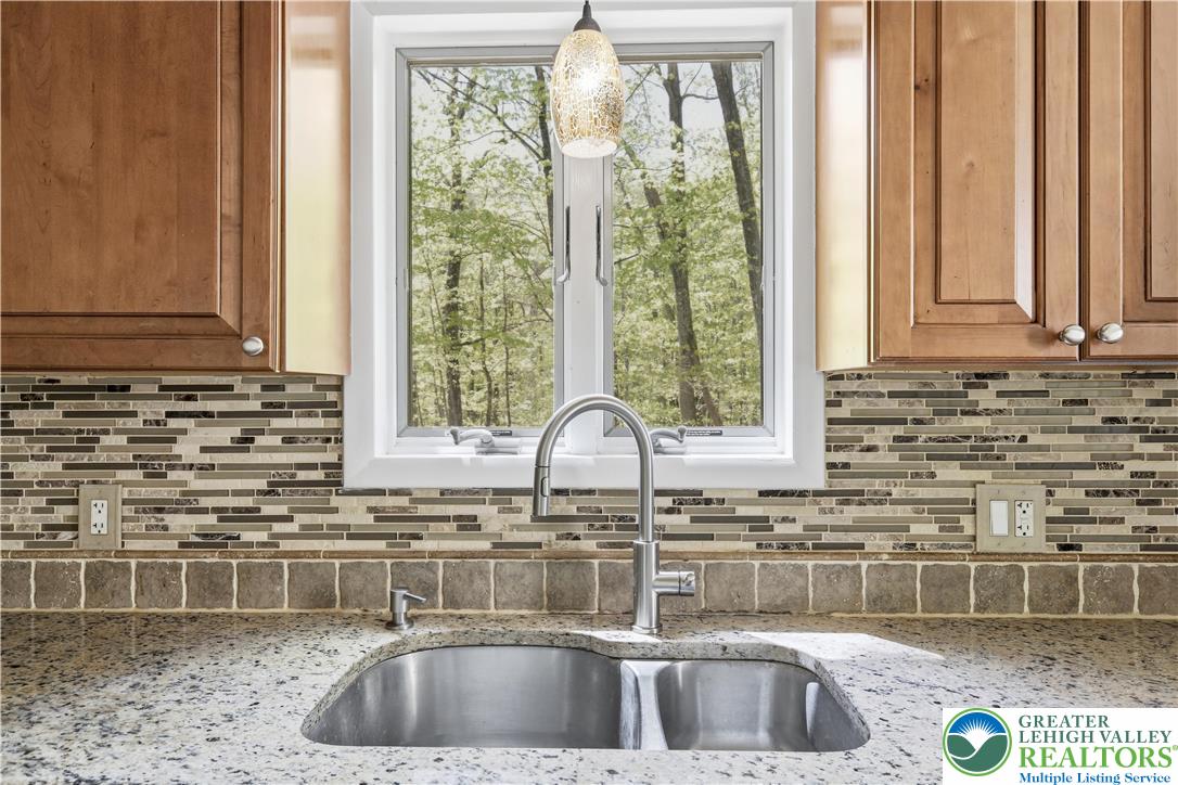 505 Chipmunk Road Bushkill, PA 18324 - Photo 10 of 46 a kitchen with granite countertop a sink and a window