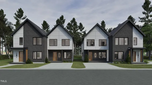 a front view of a residential apartment building with a yard