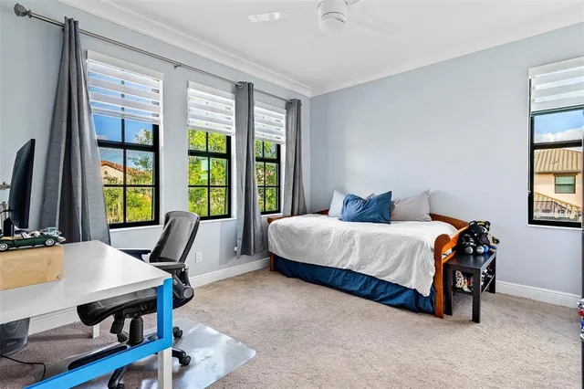 a bedroom with furniture and a large window