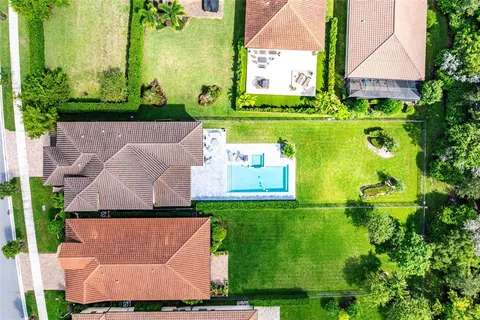 an aerial view of a house with a garden and a swimming pool