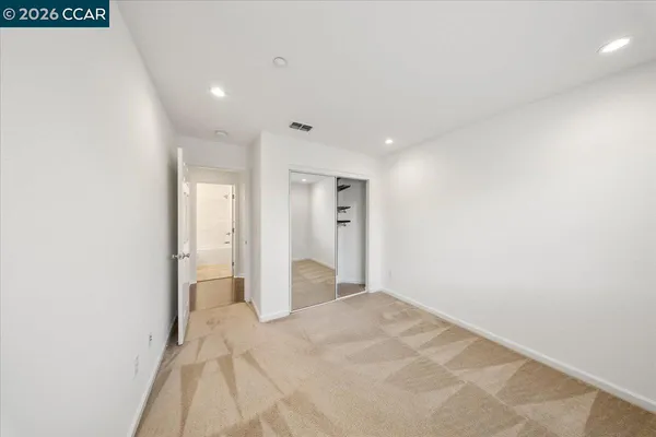 a view of a big room with closet and wooden floor