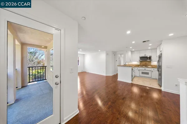 a view of large kitchen with wooden floor