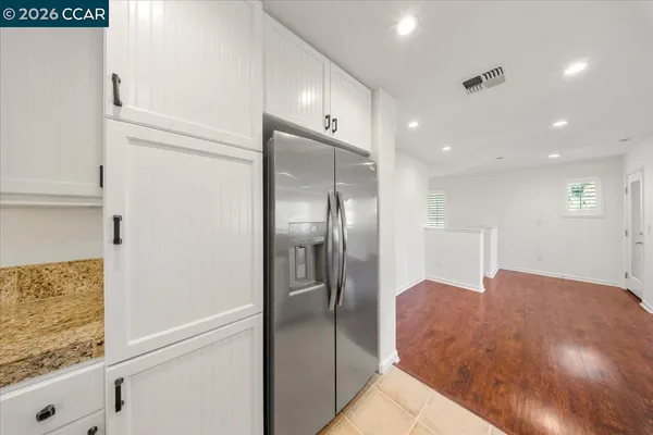 a view of a kitchen with a refrigerator and a sink
