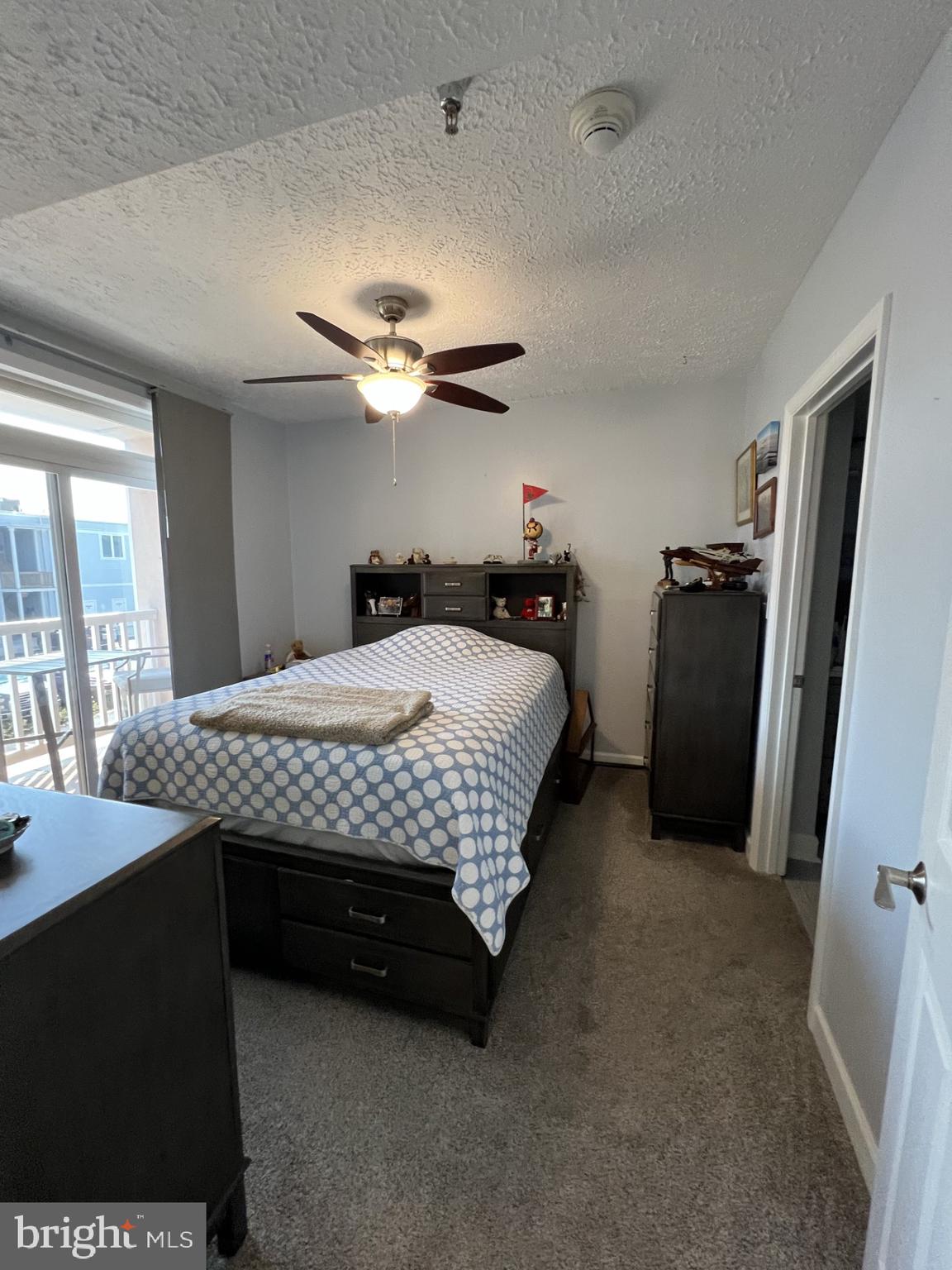 100 Taylor Street, Unit 206 Colonial Beach, VA 22443 - Photo 12 of 26 a bedroom with a bed and a chandelier