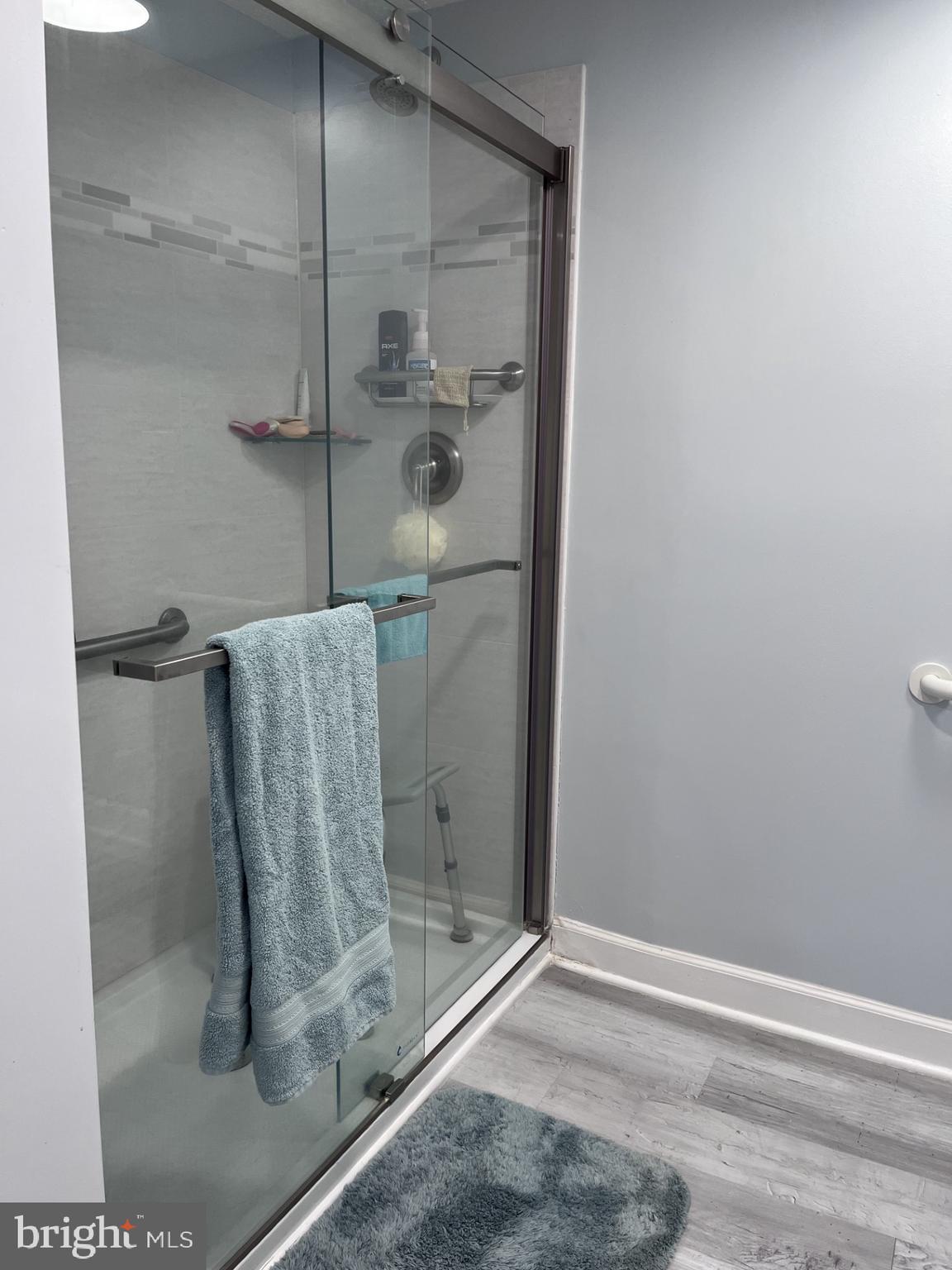 100 Taylor Street, Unit 206 Colonial Beach, VA 22443 - Photo 14 of 26 a bathroom with a glass shower door