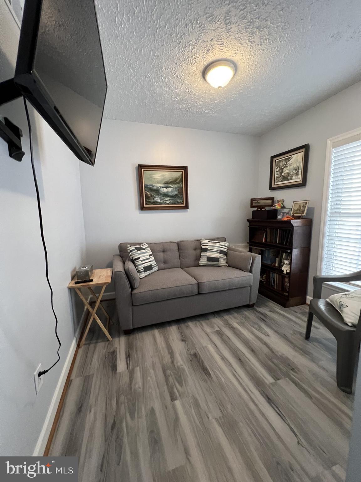 100 Taylor Street, Unit 206 Colonial Beach, VA 22443 - Photo 16 of 26 a living room with furniture and a flat screen tv