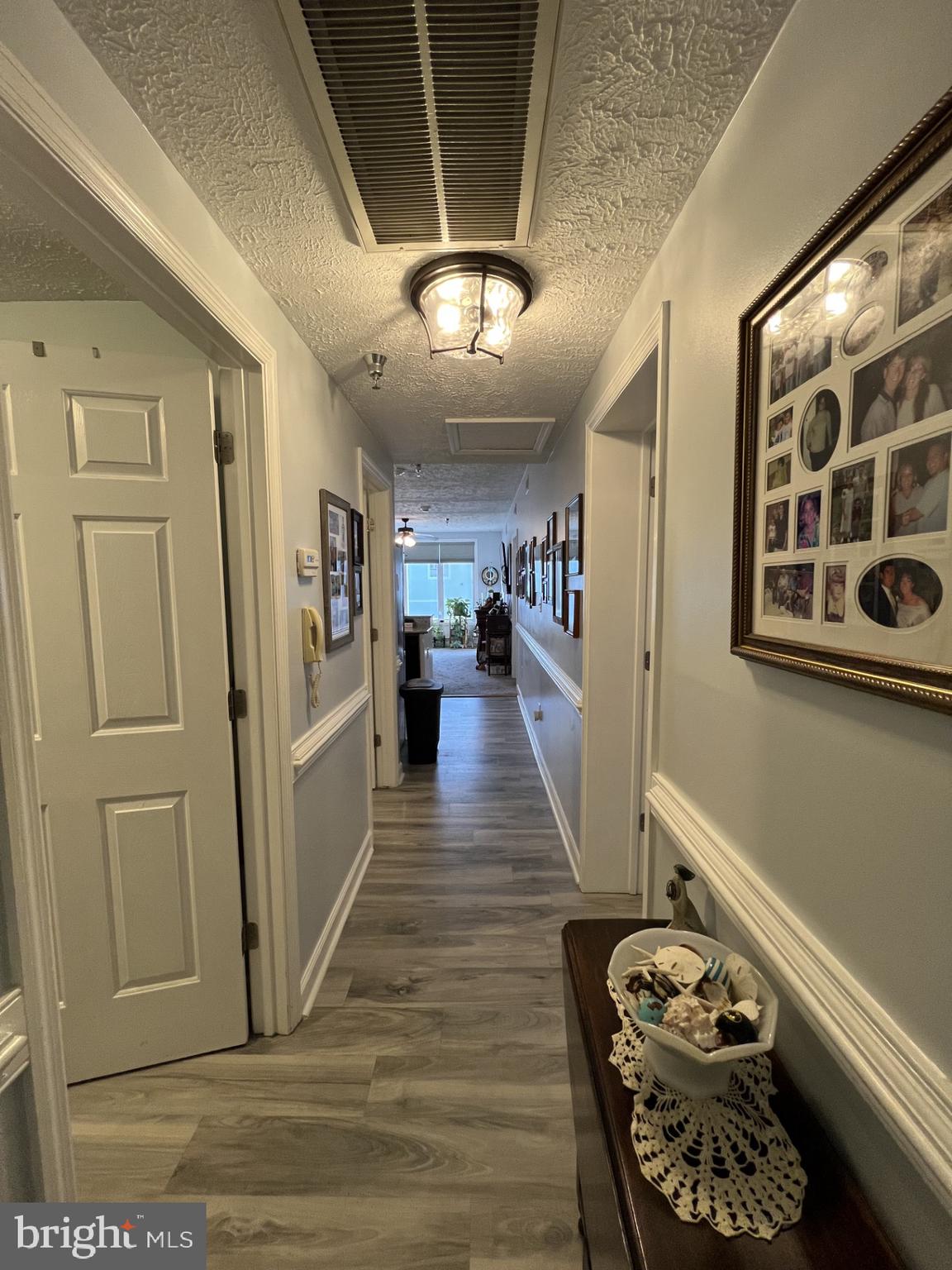 100 Taylor Street, Unit 206 Colonial Beach, VA 22443 - Photo 2 of 26 a view of a hallway with wooden floor and furniture