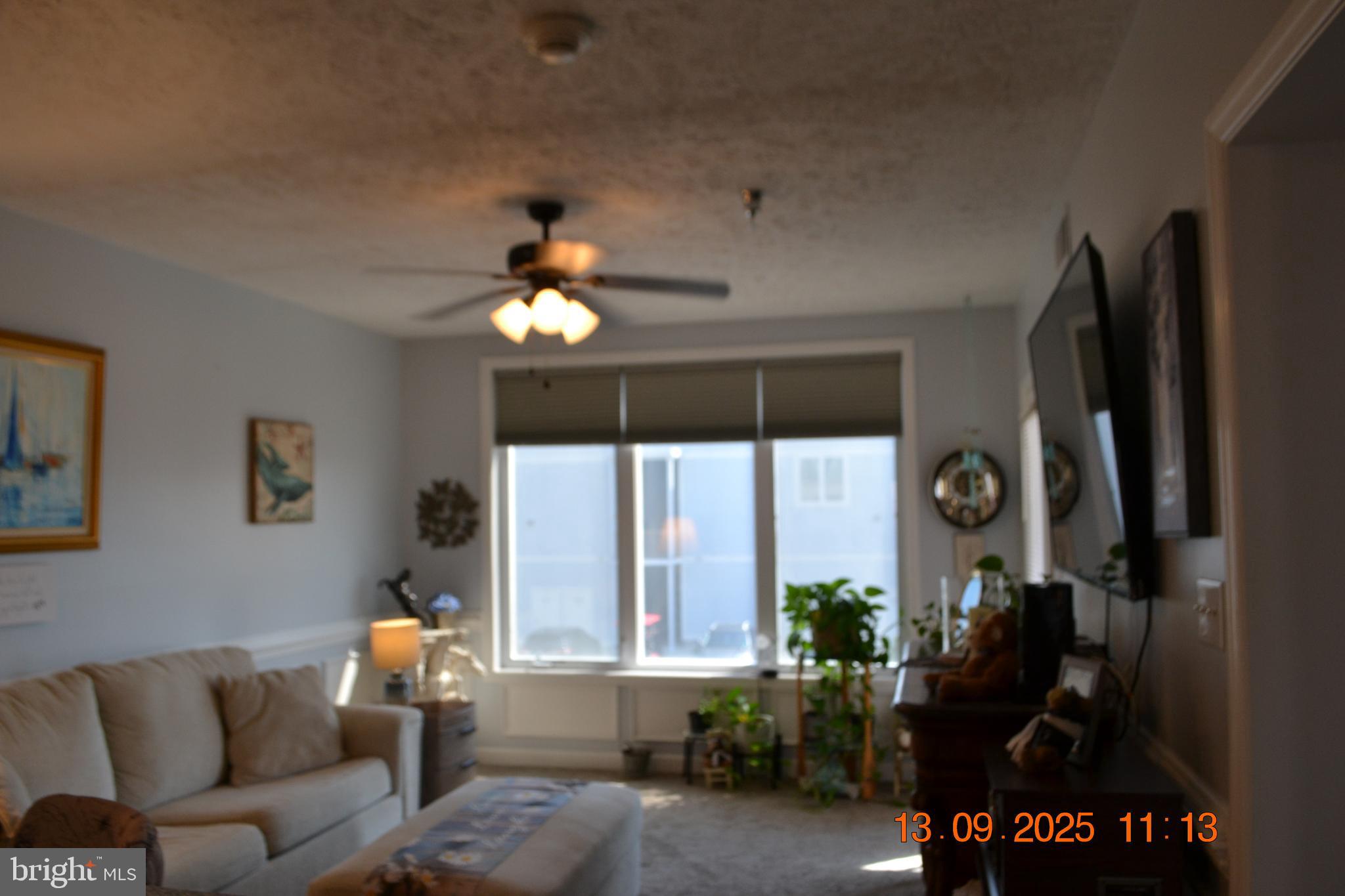 100 Taylor Street, Unit 206 Colonial Beach, VA 22443 - Photo 6 of 26 a living room with furniture and a large window