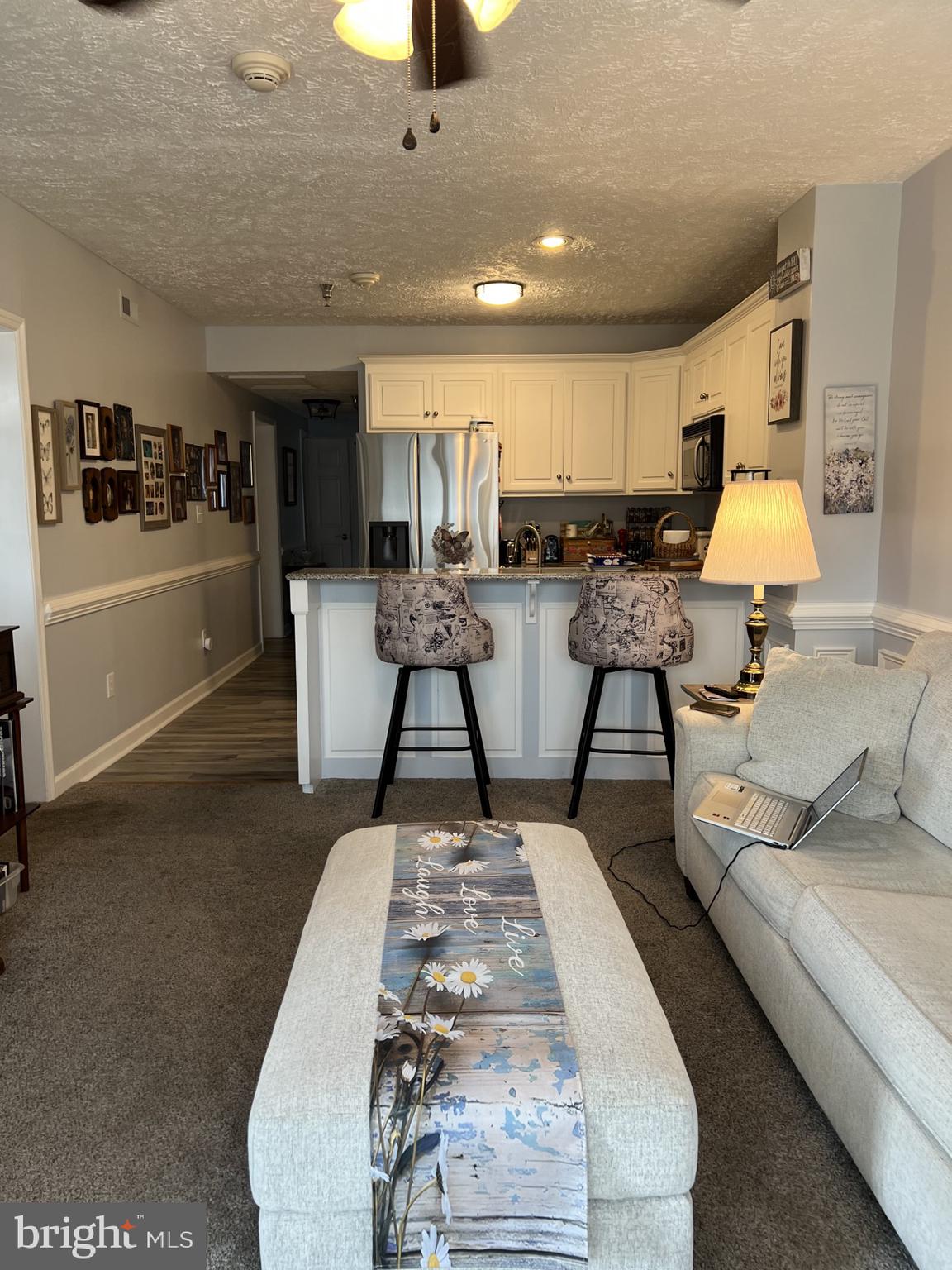 100 Taylor Street, Unit 206 Colonial Beach, VA 22443 - Photo 9 of 26 a living room with furniture and a lamp