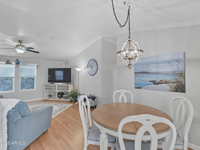 a view of a dining room with furniture and a chandelier