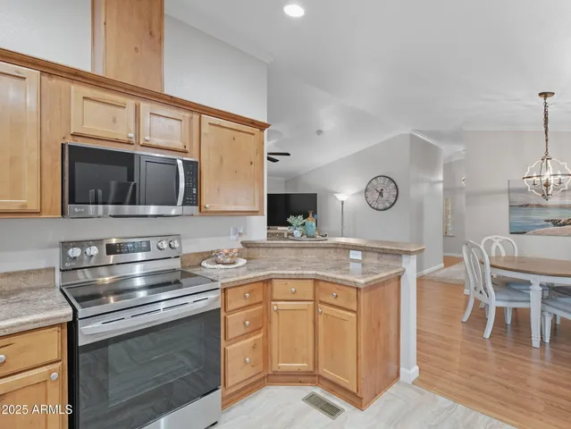 a kitchen with stainless steel appliances granite countertop a stove microwave and cabinets