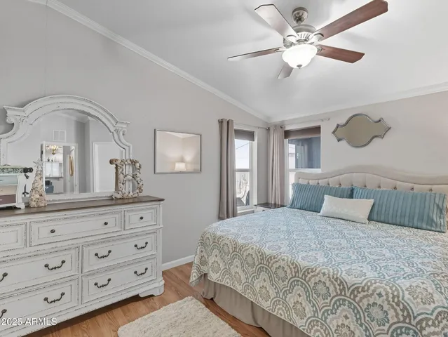a bedroom with a large bed and a mirror on dresser