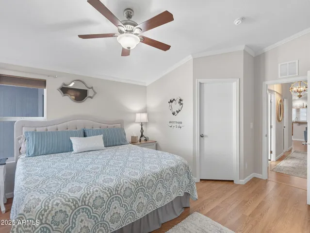 a bedroom with a large bed and a chandelier