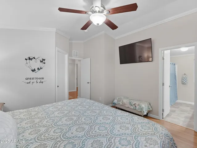 a bedroom with a large bed and a flat screen tv