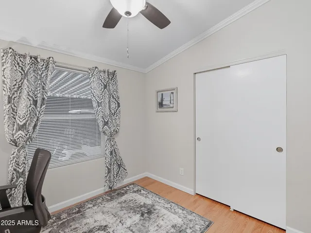 a view of a hallway with wooden floor and a chandelier