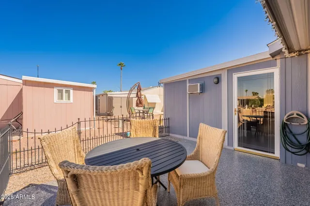 a view of a chairs and table in the balcony
