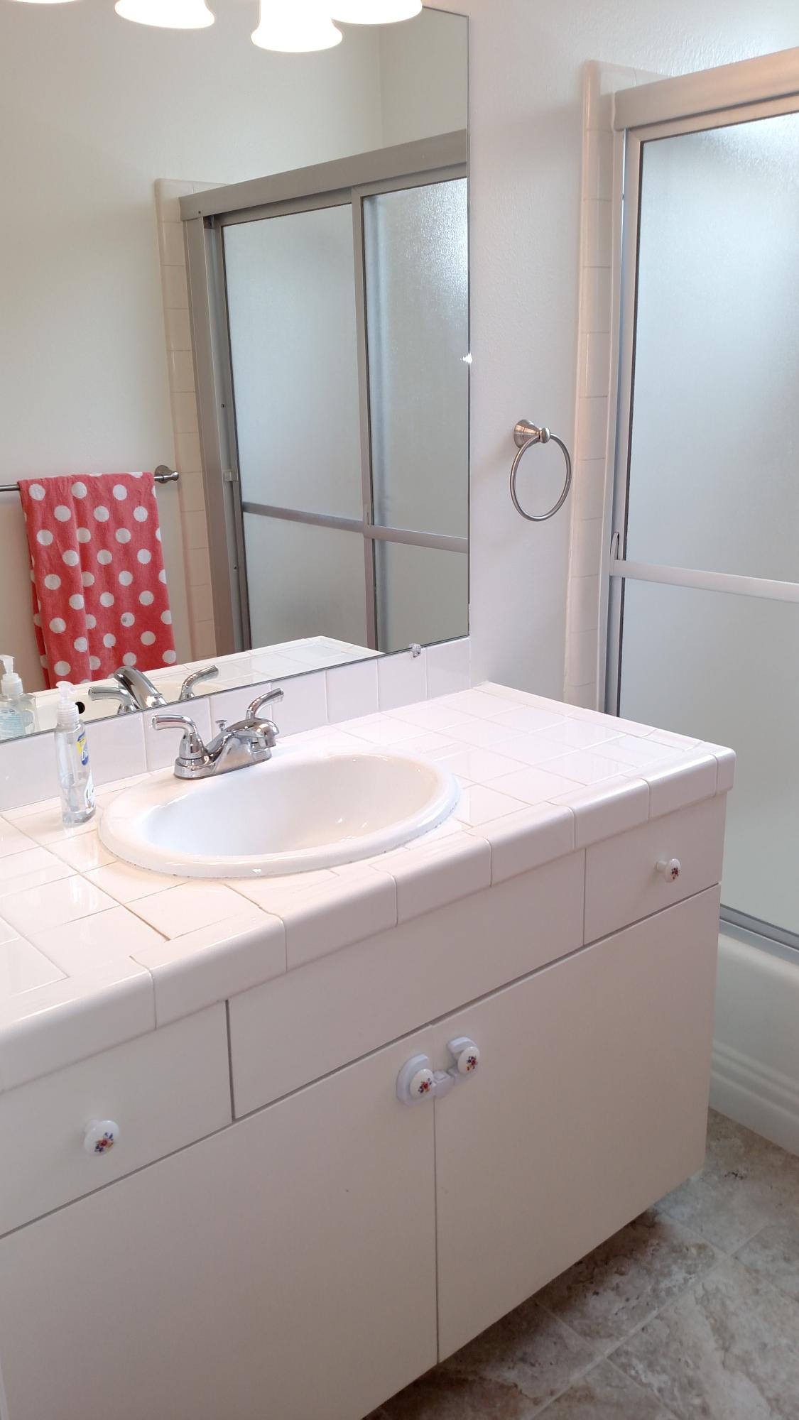 537 Windsor Avenue Goleta, CA 93117 - Photo 13 of 16 a bathroom with a sink and a mirror