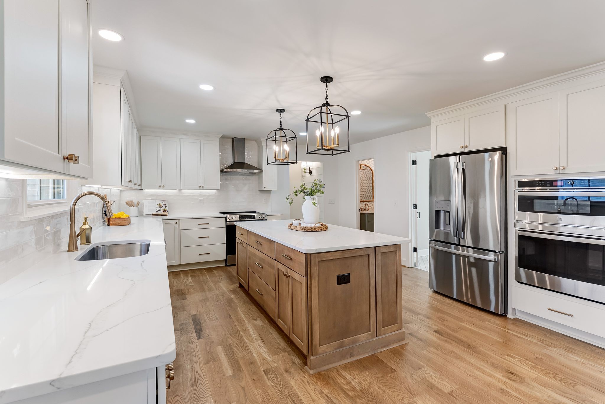 108 Poplar Street Franklin, TN 37064 - Photo 11 of 33 a kitchen with a sink wooden floor and stainless steel appliances