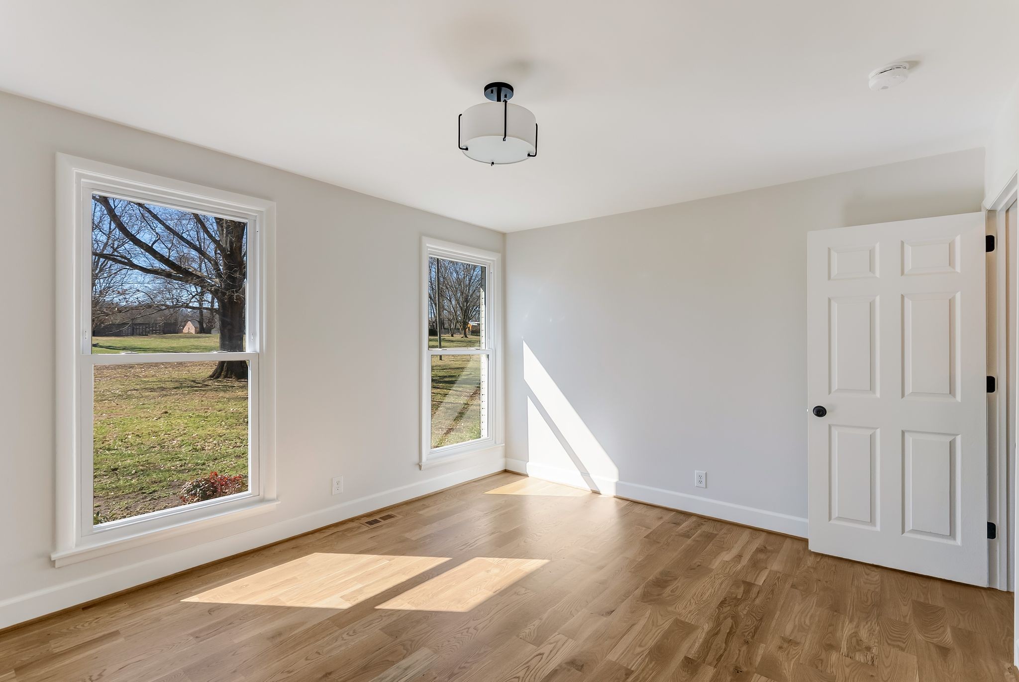 108 Poplar Street Franklin, TN 37064 - Photo 22 of 33 a view of an empty room with wooden floor and a window