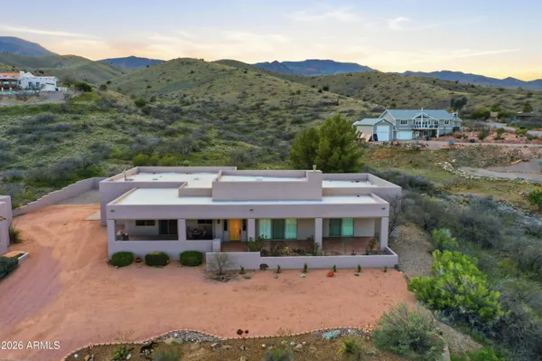 an aerial view of a house with a yard